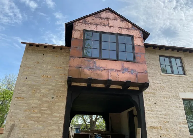 Copper metal panel facade on a stone building for Metal Roof Coating in Greenfield